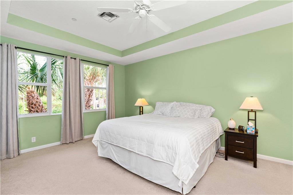 163 Southwest Walking Path Stuart, FL 34997 - Photo 22 of 37 a bedroom with a bed and a window