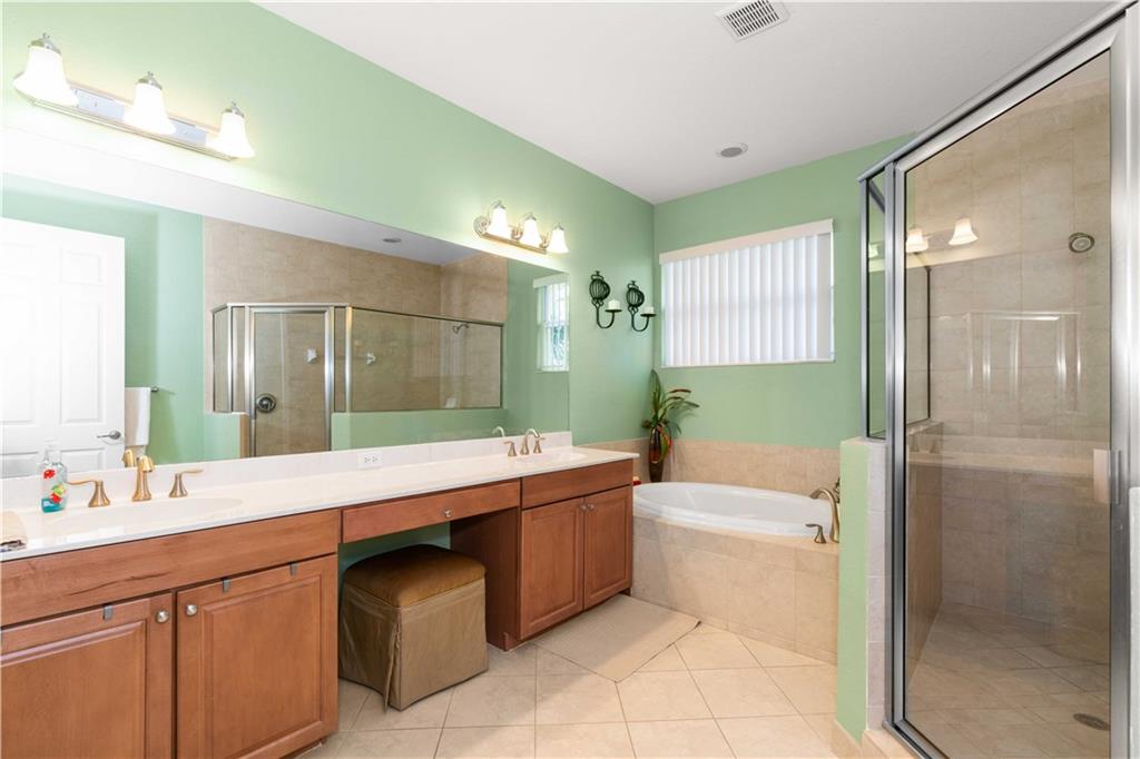 163 Southwest Walking Path Stuart, FL 34997 - Photo 26 of 37 a bathroom with a granite countertop sink toilet mirror and bathtub