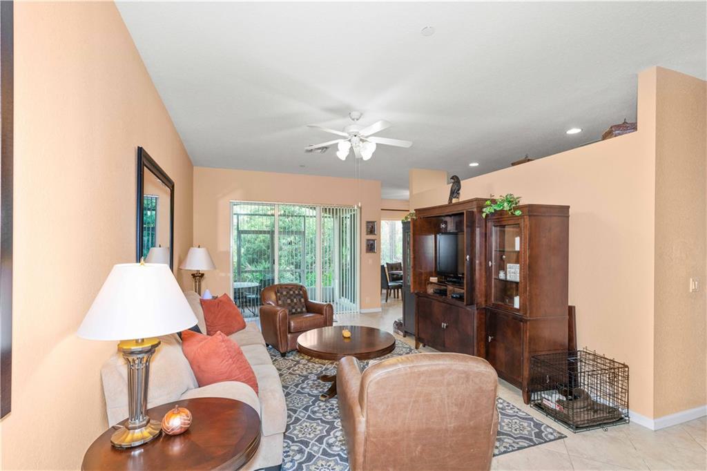 163 Southwest Walking Path Stuart, FL 34997 - Photo 3 of 37 a living room with furniture and a large window