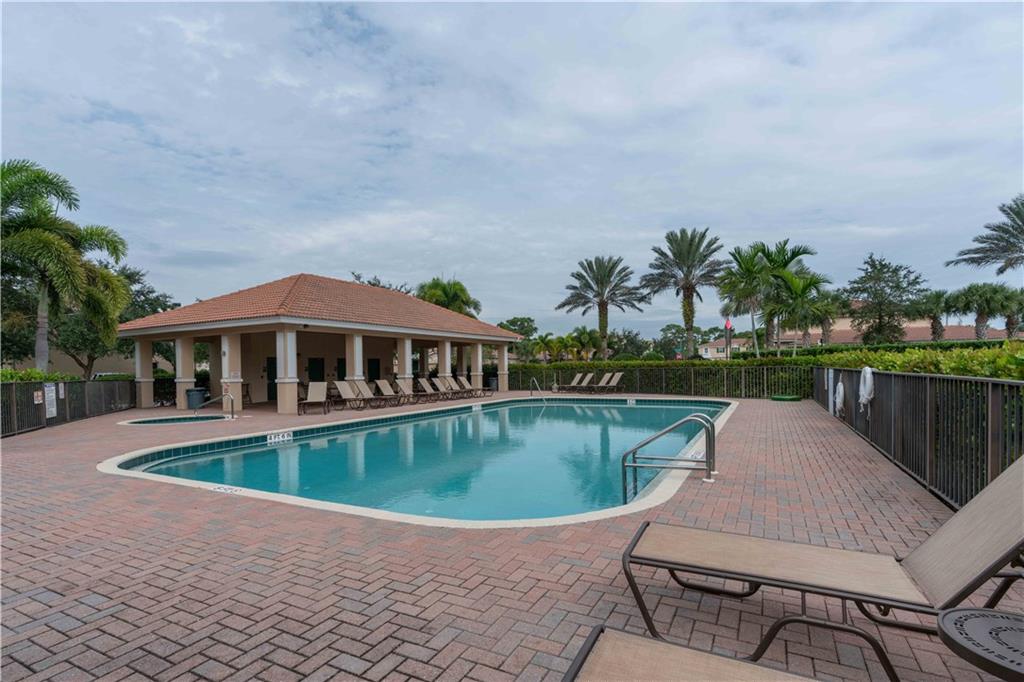 163 Southwest Walking Path Stuart, FL 34997 - Photo 37 of 37 a view of swimming pool with outdoor seating and yard in back