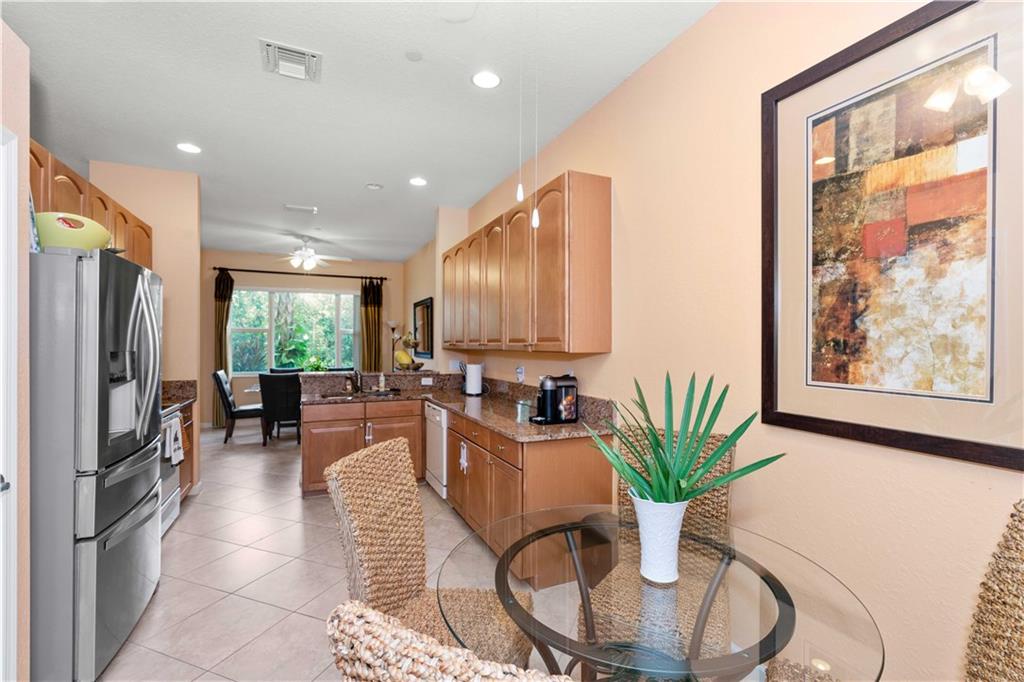 163 Southwest Walking Path Stuart, FL 34997 - Photo 8 of 37 a dining room with furniture potted plants and wooden floor