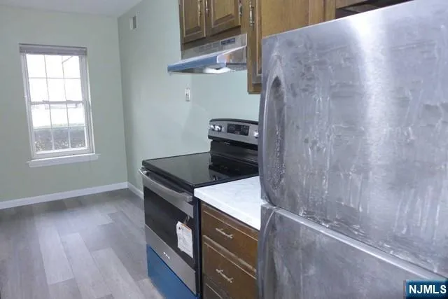 a kitchen with a wooden floor and a stove
