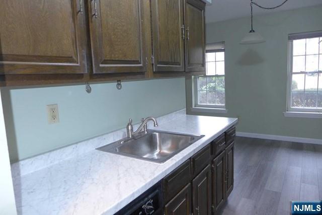 350 Maple Avenue, Unit 1 Oradell, NJ 07649 - Photo 4 of 9 a kitchen with granite countertop a sink a stove and cabinets