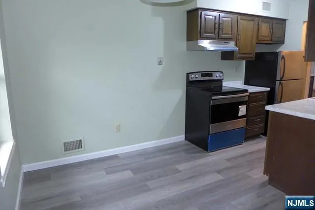 a kitchen with stainless steel appliances a stove and a refrigerator
