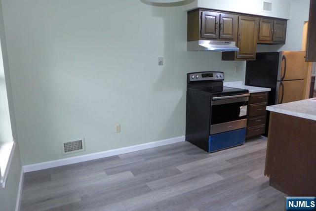 350 Maple Avenue, Unit 1 Oradell, NJ 07649 - Photo 5 of 9 a kitchen with stainless steel appliances a stove and a refrigerator
