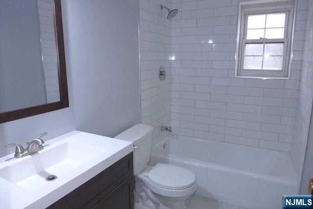 350 Maple Avenue, Unit 1 Oradell, NJ 07649 - Photo 8 of 9 a bathroom with a sink toilet vanity and bathtub