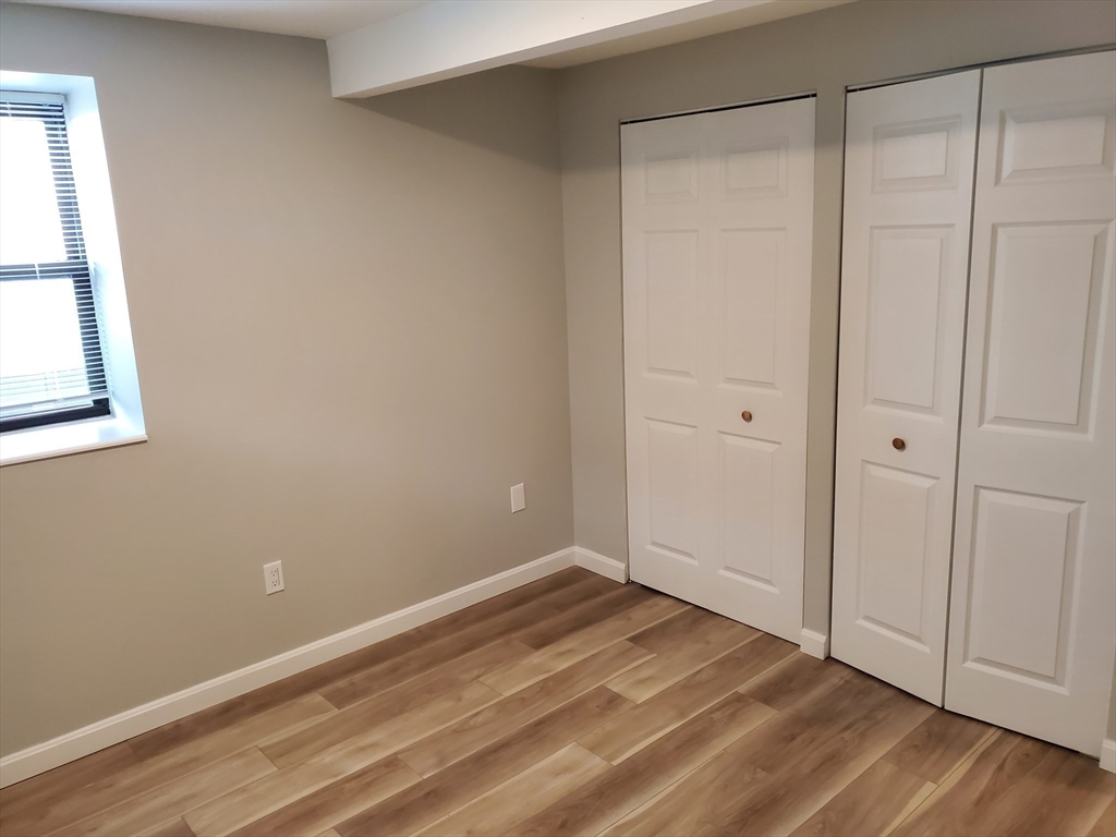 33 Brainerd Road, Unit 112 Boston, MA 02134 - Photo 12 of 23 a view of an empty room with wooden floor and closet area