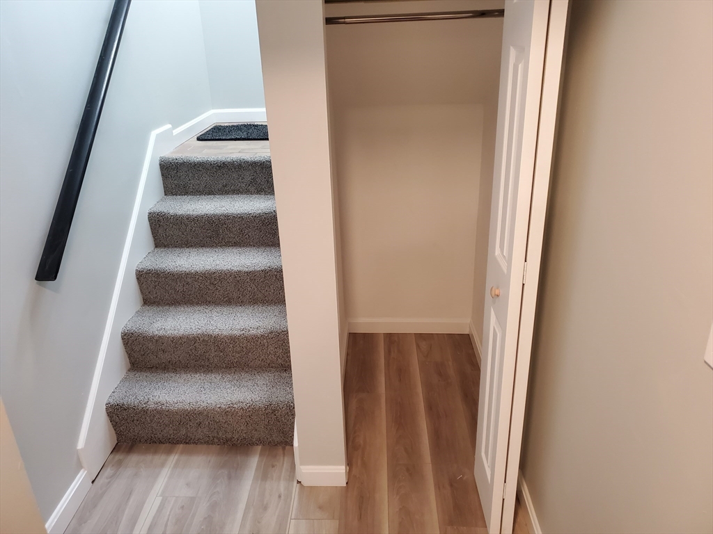 33 Brainerd Road, Unit 112 Boston, MA 02134 - Photo 15 of 23 a view of staircase with white walls and a window