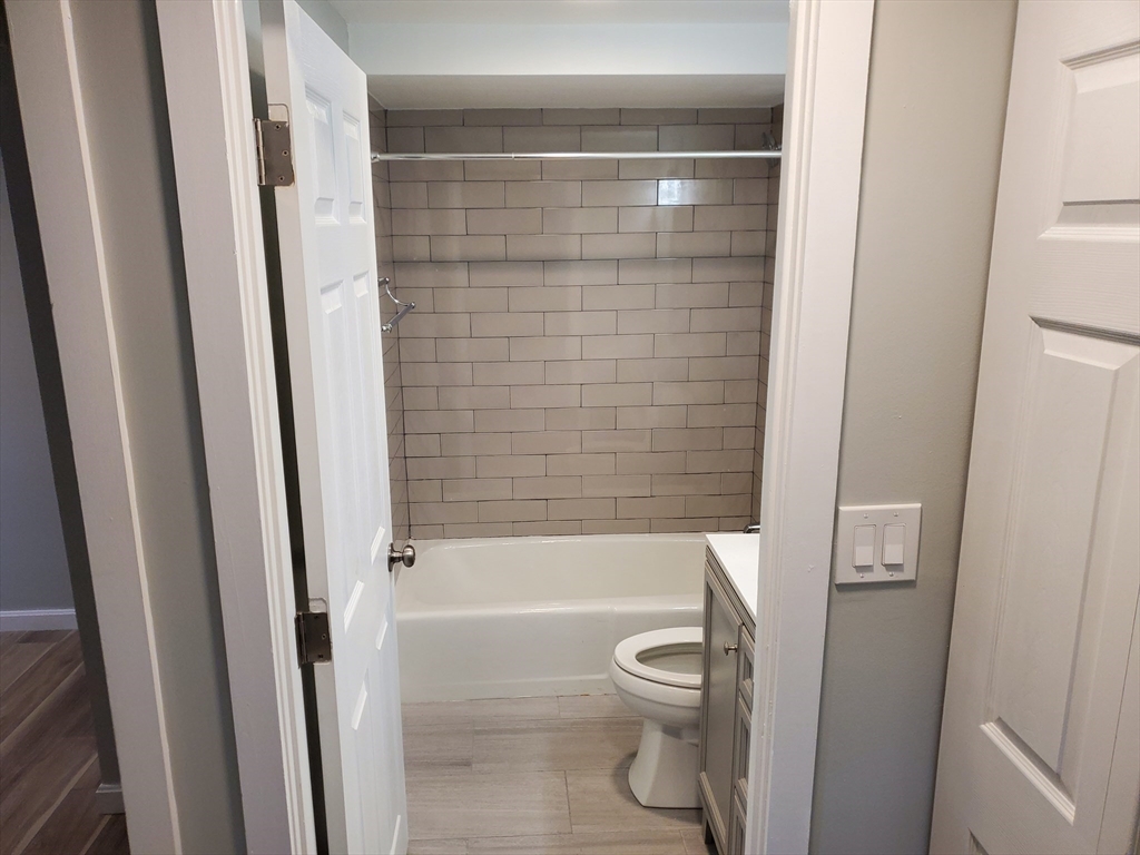 33 Brainerd Road, Unit 112 Boston, MA 02134 - Photo 18 of 23 a bathroom with a shower and a toilet