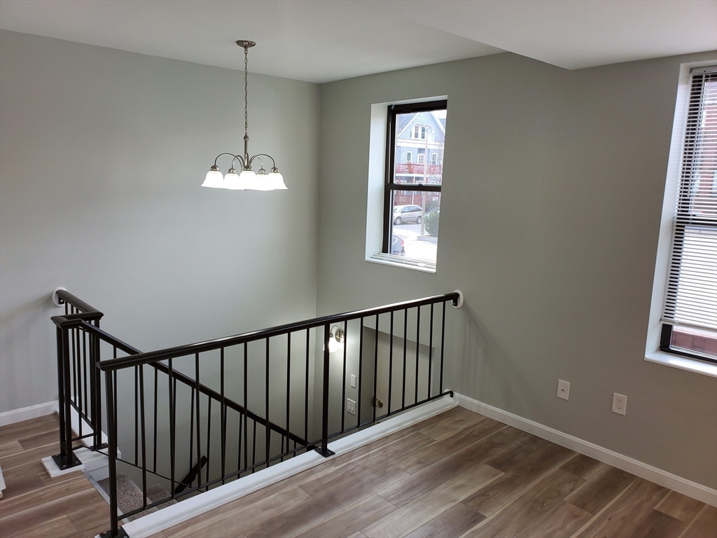 33 Brainerd Road, Unit 112 Boston, MA 02134 - Photo 23 of 23 a view of a hallway with windows and chandelier