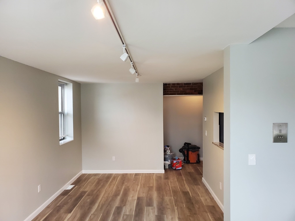 33 Brainerd Road, Unit 112 Boston, MA 02134 - Photo 3 of 23 a view of empty room with wooden floor