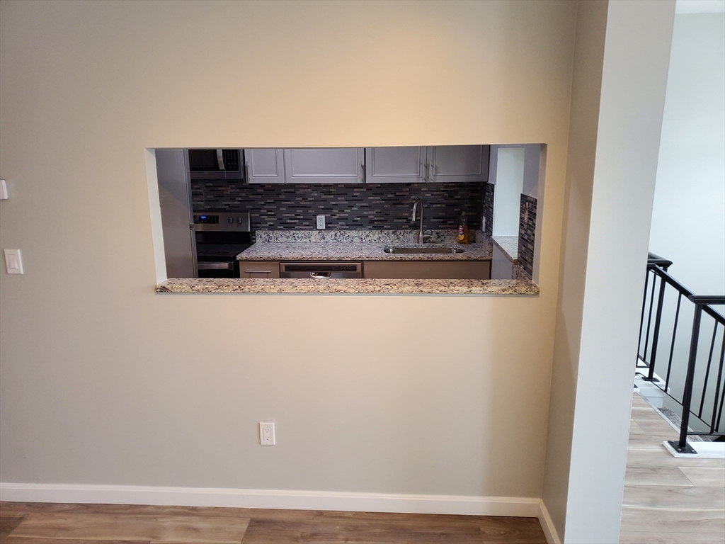 33 Brainerd Road, Unit 112 Boston, MA 02134 - Photo 7 of 23 a view of kitchen with stainless steel appliances wooden floor