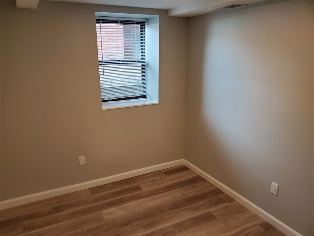 33 Brainerd Road, Unit 112 Boston, MA 02134 - Photo 10 of 23 a view of a small space with wooden floor and a window
