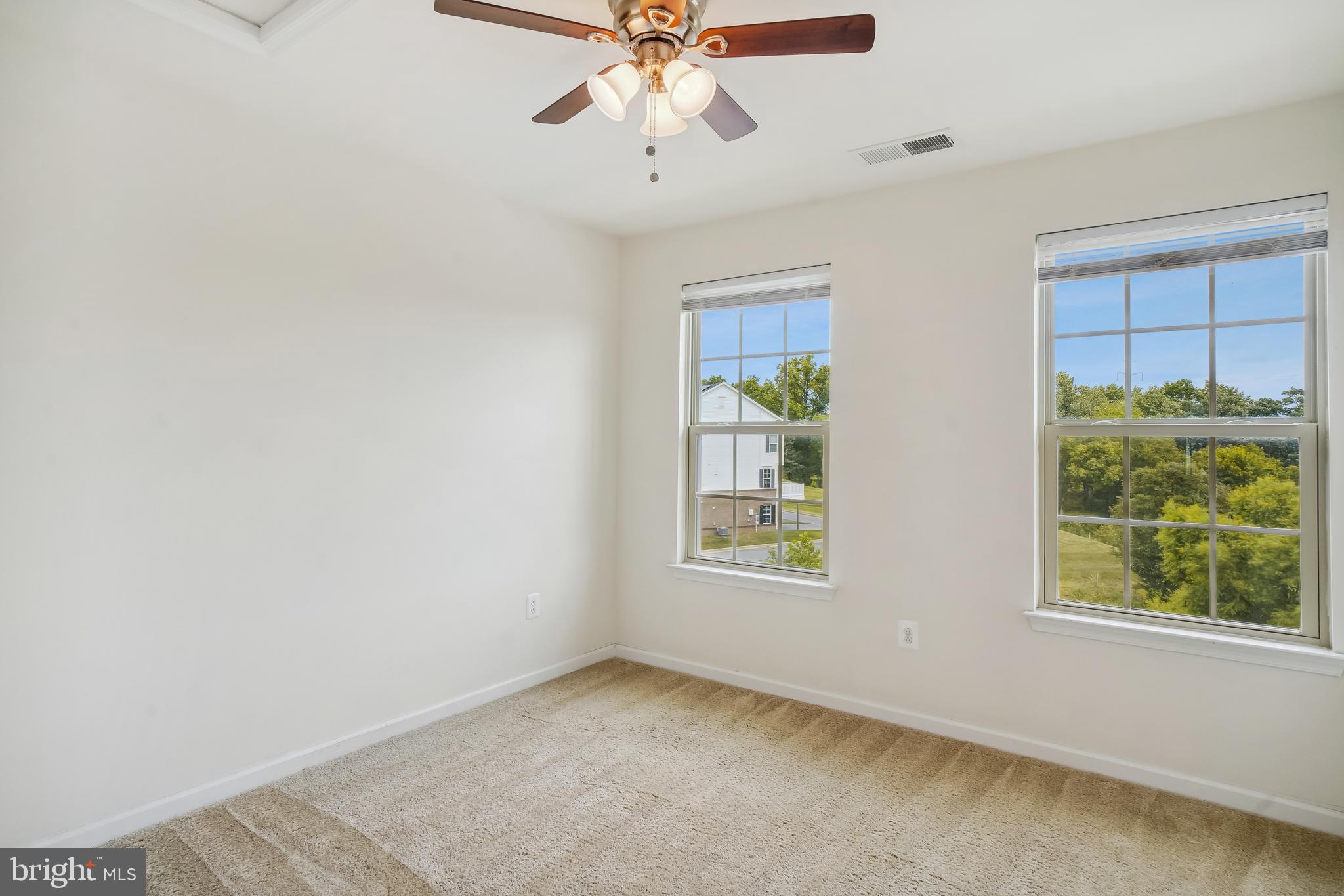 5934 Jefferson Commons Way Frederick, MD 21703 - Photo 18 of 27 an empty room with windows and chandelier fan