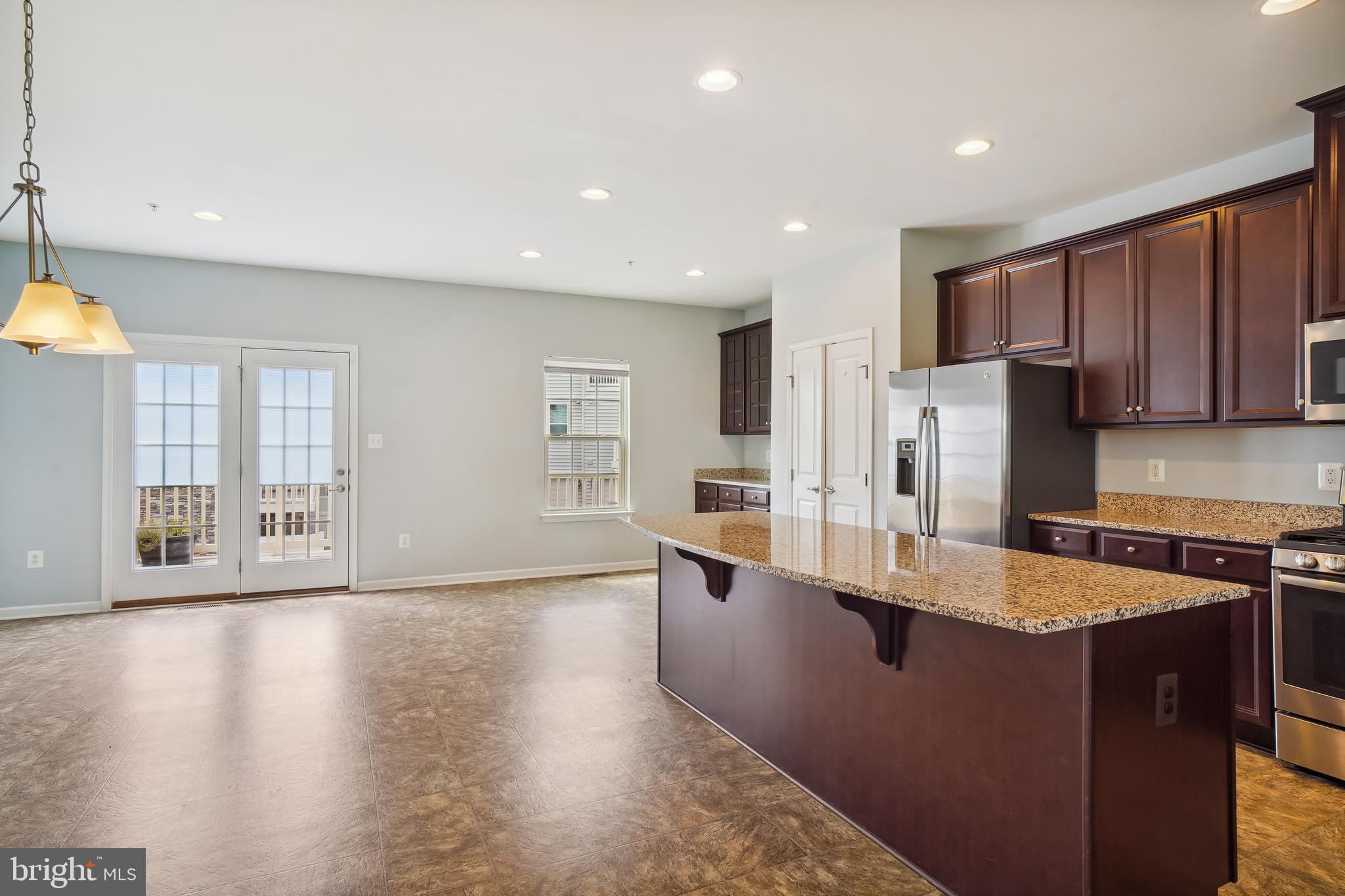 5934 Jefferson Commons Way Frederick, MD 21703 - Photo 9 of 27 a large kitchen with stainless steel appliances granite countertop a sink a stove and a refrigerator
