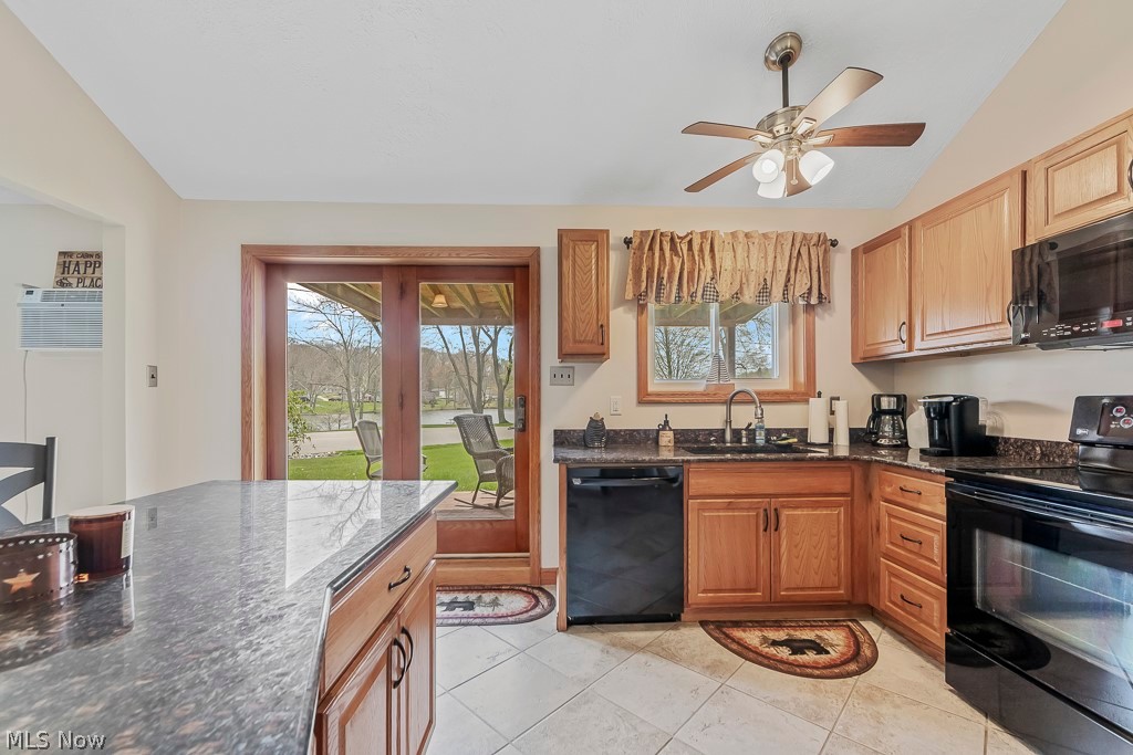 6939 Lakeview Road Hanoverton, OH 44423 - Photo 9 of 42 Kitchen with a healthy amount of sunlight, black appliances, light ceramic tile floors, and sink