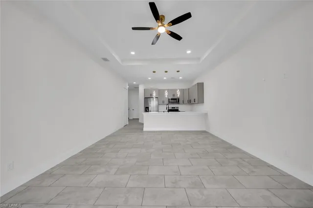 a view of a kitchen with a sink and a chandelier fan