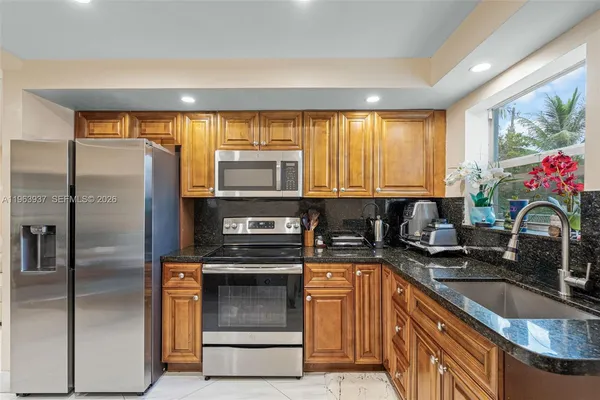 a kitchen with a refrigerator sink and microwave