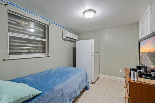 a bedroom with a bed and a flat screen tv