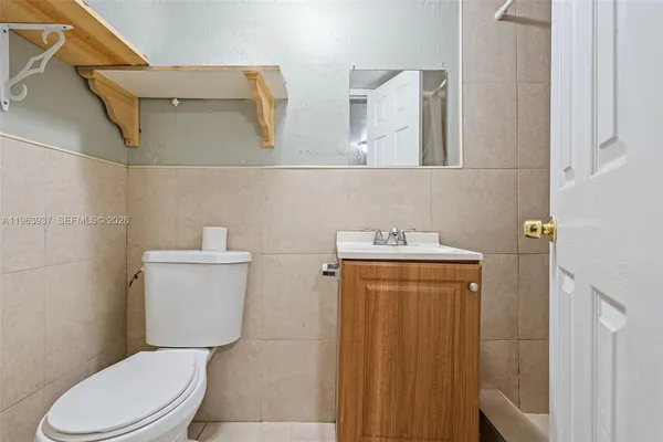 a white toilet sitting next to a bathroom sink