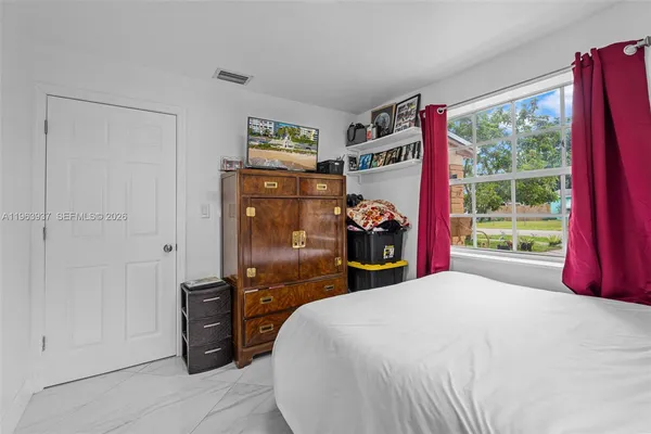 a bed room with a bed and a window