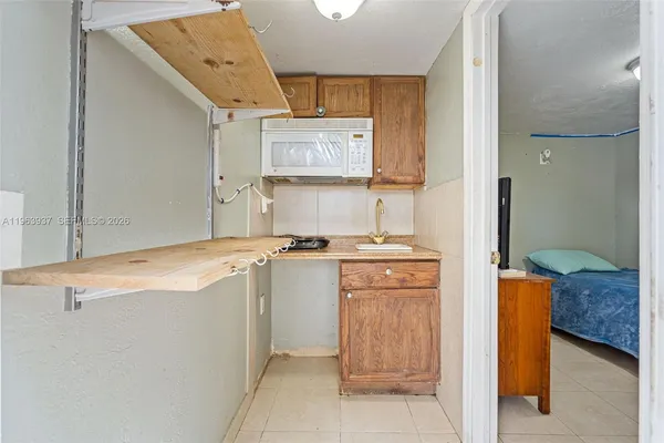 a room with granite countertop cabinets and sink