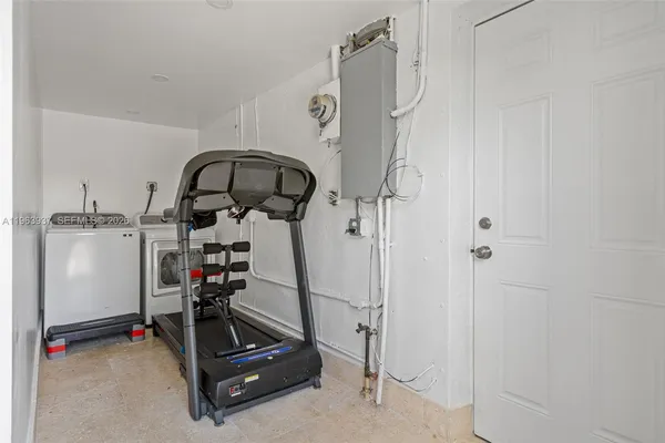 a room with gym equipment and white walls