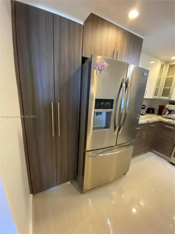a view of a refrigerator in kitchen and wooden floor