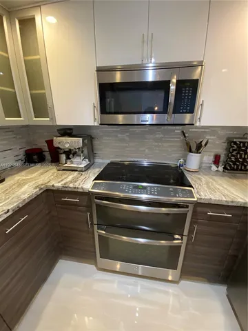 a kitchen with a stove and a microwave