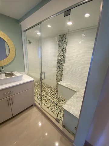 a bathroom with a double vanity sink mirror and shower