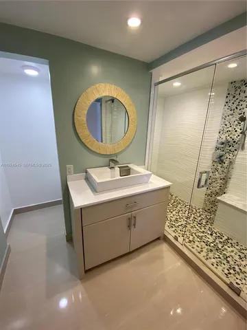 a bathroom with a sink mirror vanity and toilet