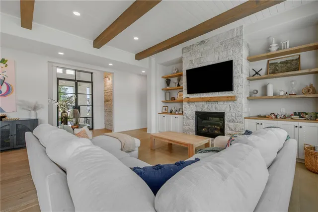 a living room with furniture fireplace and flat screen tv