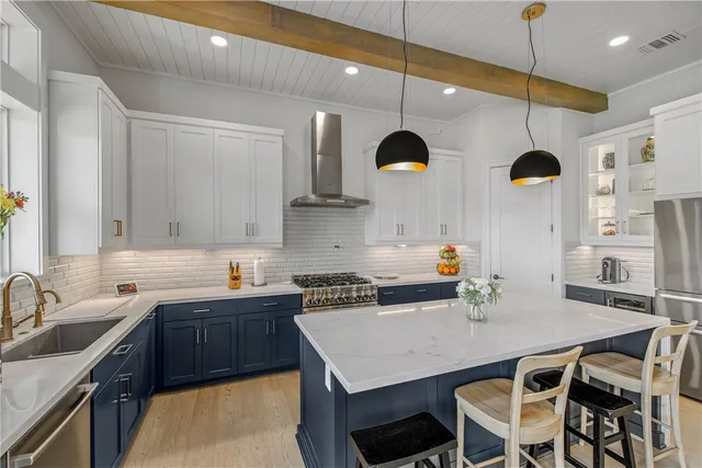 a kitchen with a table chairs sink and cabinets