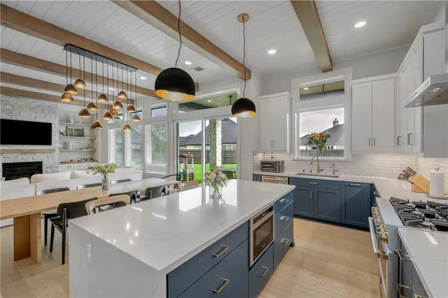 a large kitchen with lots of counter space and sink