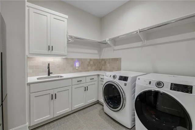 a utility room with sink dryer and washer