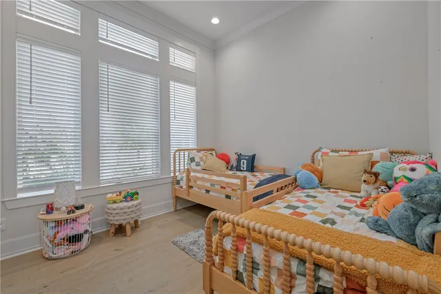 a bedroom with two beds and a window