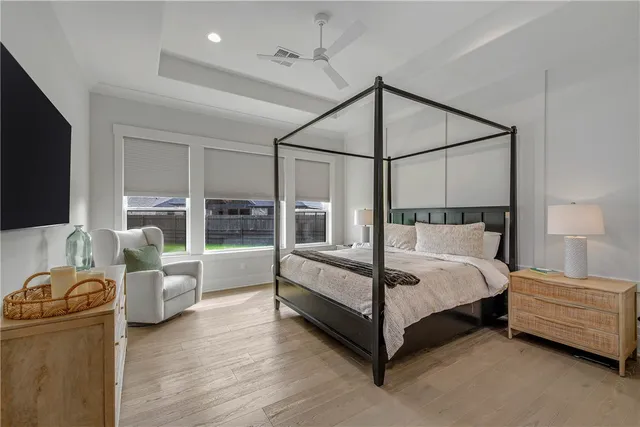 a bedroom with a bed and glass walk in closet