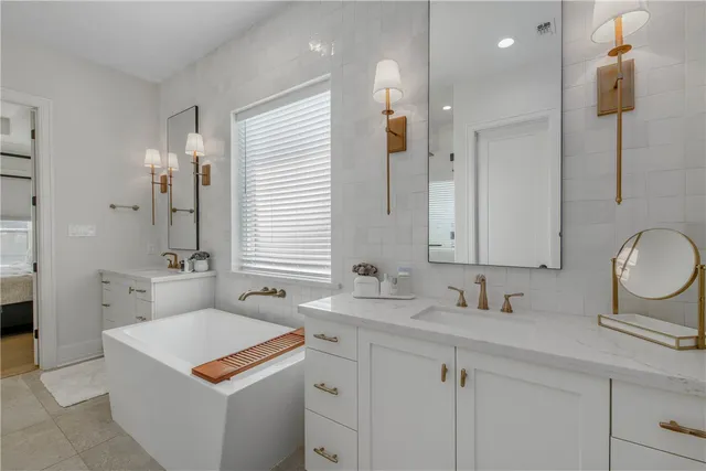 a bathroom with a sink double vanity granite and a mirror