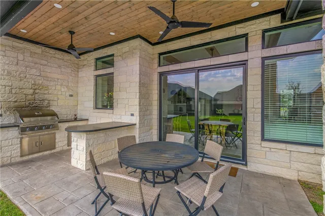 a view of a patio with a table and chairs