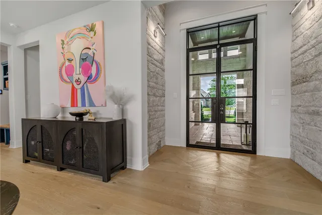 an entryway with painting on the wall