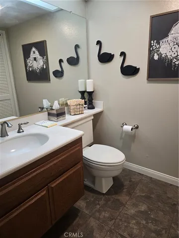 a bathroom with a toilet a sink and mirror