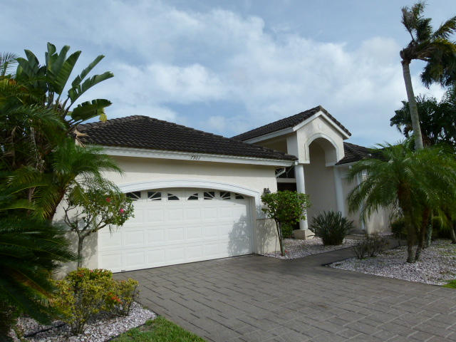 7901 Dorchester Road Boynton Beach, FL 33472 - Photo 2 of 14 a front view of a house with a yard and garage