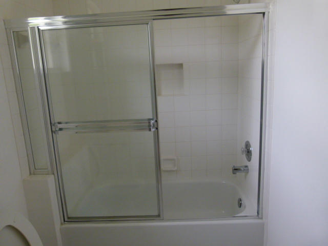7901 Dorchester Road Boynton Beach, FL 33472 - Photo 10 of 14 a bathroom with a glass shower door