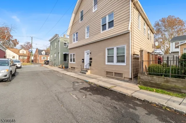 a couple of cars parked in front of a house