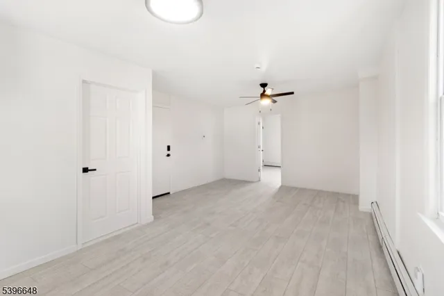a view of a room with wooden floor