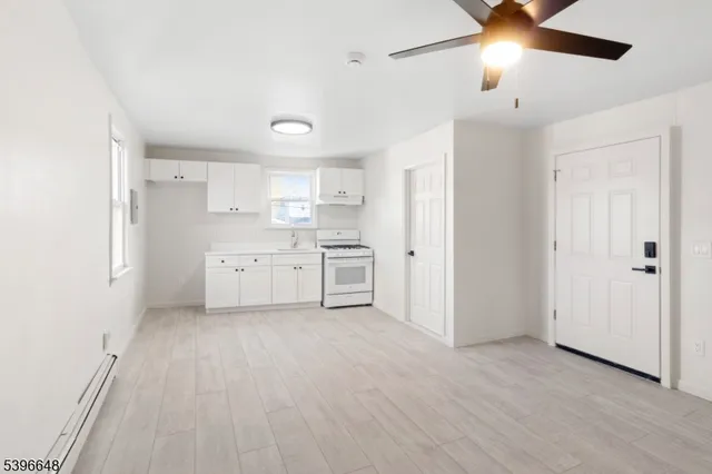 a view of a kitchen with a sink and a refrigerator