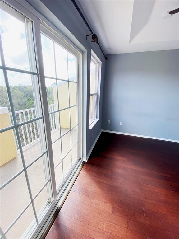 8946 White Sage Loop Lakewood Ranch, FL 34202 - Photo 16 of 36 wooden floor in an empty room with a window