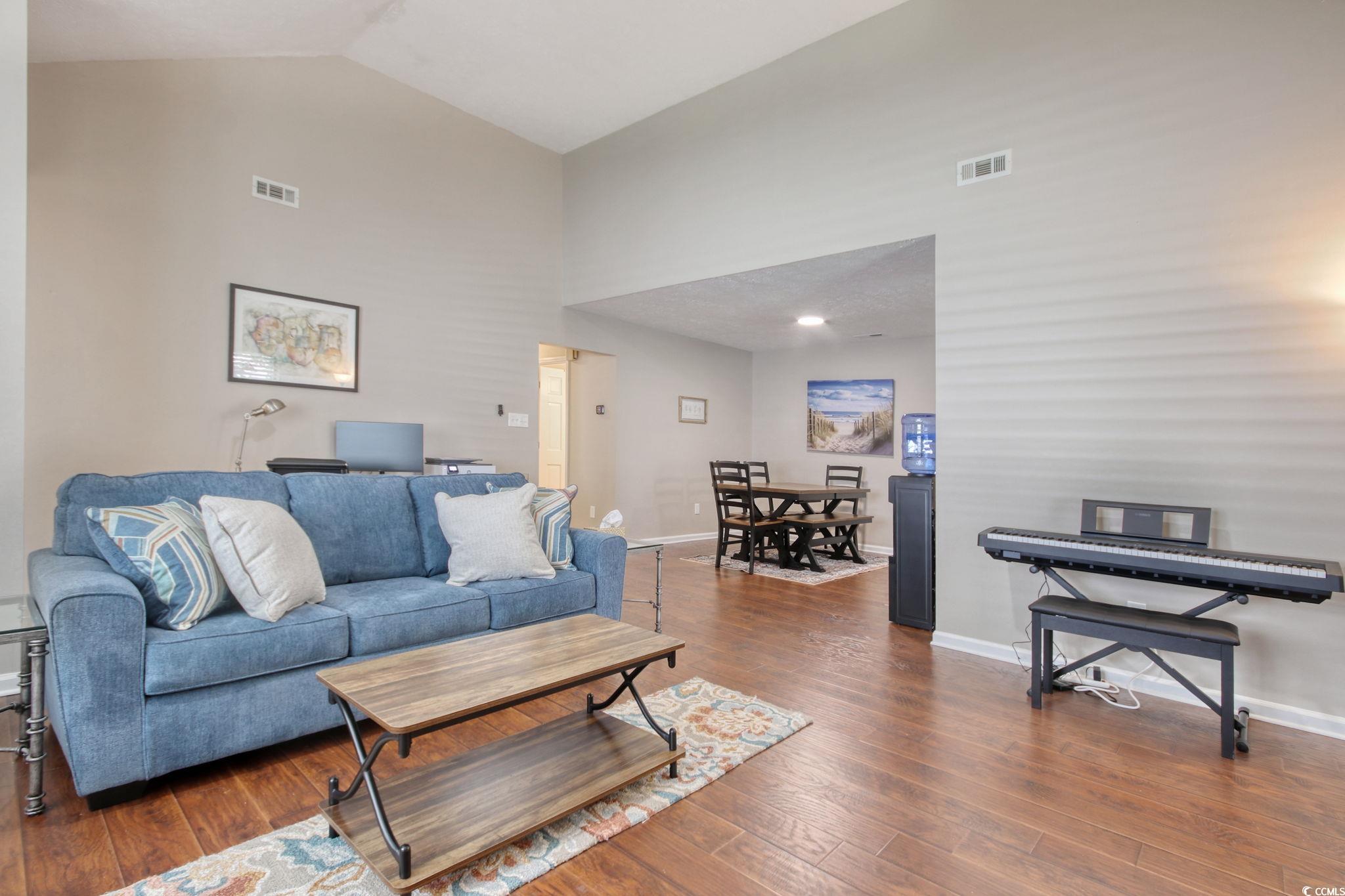 3931 Pinebrook Circle Little River, SC 29566 - Photo 12 of 32 Living room featuring wood flooring and high vaulted ceiling