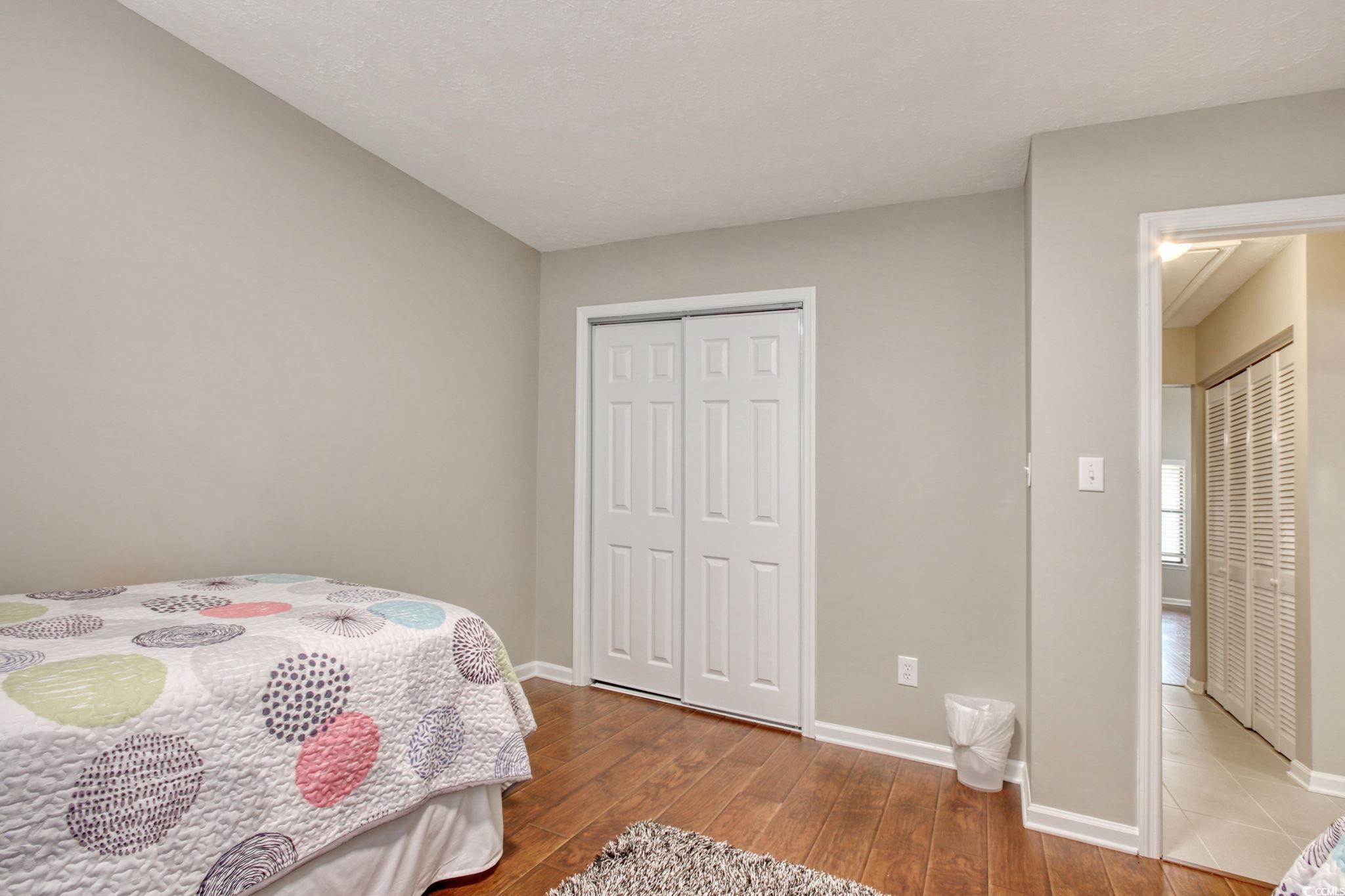 3931 Pinebrook Circle Little River, SC 29566 - Photo 20 of 32 Second bedroom featuring wood flooring and a walk-in closet