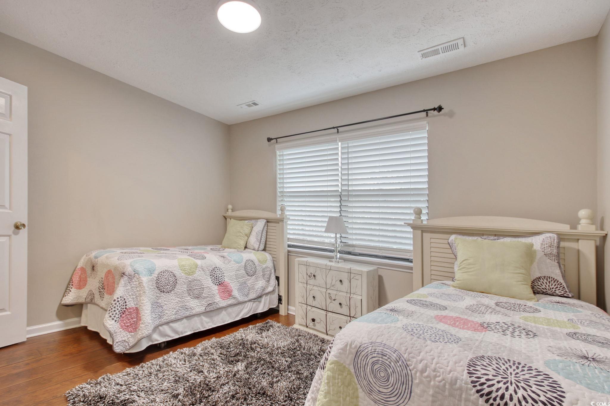 3931 Pinebrook Circle Little River, SC 29566 - Photo 21 of 32 Second bedroom featuring wood flooring and a walk-in closet